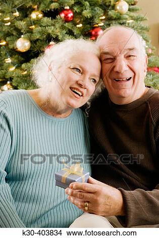 Elderly couple with Christmas tree. View Large Photo Image Picture - Elderly couple with Christmas tree.. Fotosearch