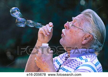Elderly gentleman blowing bubbles View Large Photo Image Stock Photo - Elderly gentleman blowing bubbles. Fotosearch