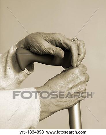 Elderly lady at home with hand on walking stick View Large Photo Image Stock Photo - Elderly lady at home with hand on walking stick. Fotosearch