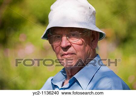 Elderly man in his spring garden in the Uk View Large Photo Image Stock Image - Elderly man in his spring garden in the Uk. Fotosearch