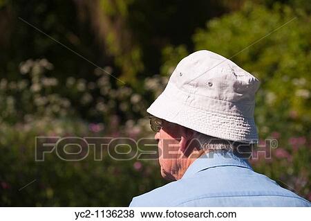 Elderly man looks out to his spring garden in the Uk View Large Photo Image Stock Photo - Elderly man looks out to his spring garden in the Uk. Fotosearch