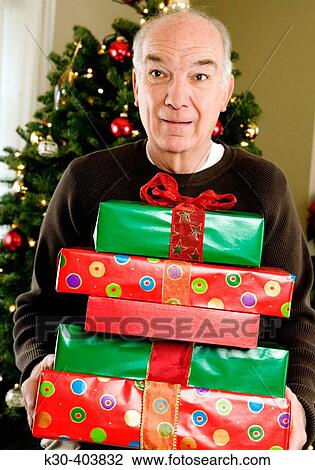 Elderly man with Christmas gifts. View Large Photo Image Stock Image - Elderly man with Christmas gifts.. Fotosearch