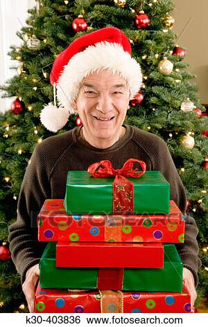 Elderly man with Christmas gifts. View Large Photo Image Stock Photograph - Elderly man with Christmas gifts.. Fotosearch