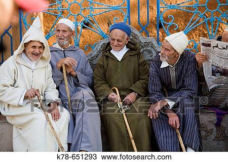 Elderly men sitting at Plaza uta el hammam square in Chefchaouen, Rif mountains region, Morocco. View Large Photo Image Stock Image - Elderly men sitting at Plaza uta el hammam square in Chefchaouen, Rif mountains region, Morocco.. Fotosearch