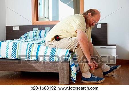 Elderly person using a mobile tele care device for automatic detection of falls that sits at the waist View Large Photo Image Stock Image - Elderly person using a mobile tele care device for automatic detection of falls that sits at the waist. Fotosearch
