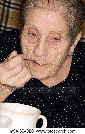 Elderly woman eating cereals View Large Photo Image Stock Image - Elderly woman eating cereals. Fotosearch