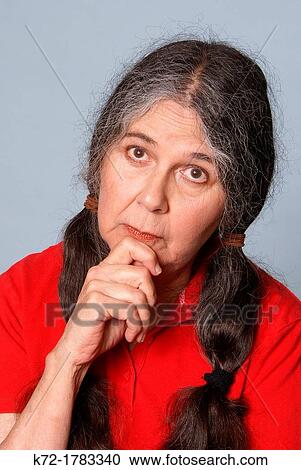 Elderly woman giving something some serious thought View Large Photo Image Stock Image - Elderly woman giving something some serious thought. Fotosearch