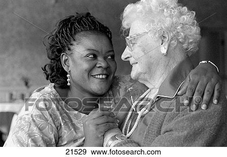 Stock Photo - Elderly woman in nursing home with health care provider. Fotosearch
