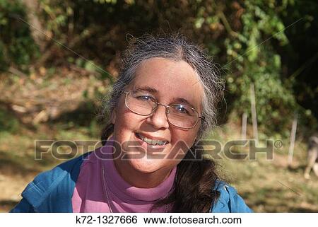 Elderly woman smiling at camera outside View Large Photo Image Stock Photograph - Elderly woman smiling at camera outside. Fotosearch