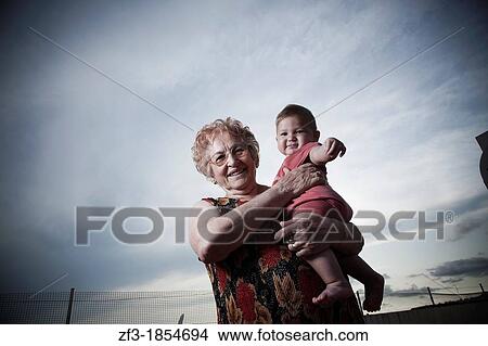 Elderly women with a baby in arms View Large Photo Image Picture - Elderly women with a baby in arms. Fotosearch