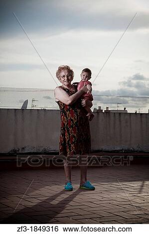 Elderly women with a baby in arms View Large Photo Image Stock Photograph - Elderly women with a baby in arms. Fotosearch