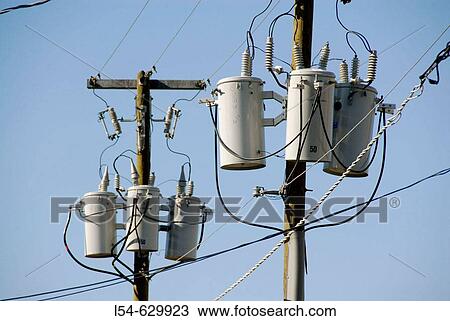 Electrical transformers located on poles in a residential neighborhoos View Large Photo Image Stock Image - Electrical transformers located on poles in a residential neighborhoos. Fotosearch