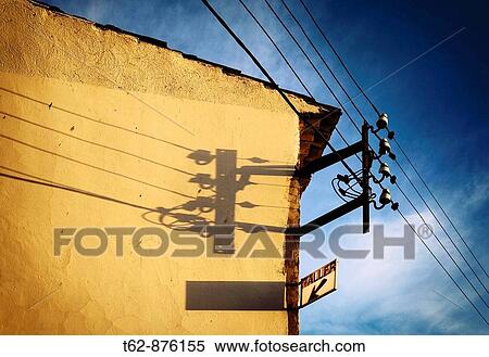 Electricity pole in a yellow wall illuminated by the sun in the evening Spain View Large Photo Image Stock Photography - Electricity pole in a yellow wall illuminated by the sun in the evening Spain. Fotosearch