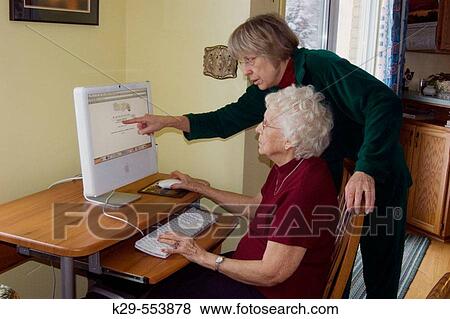 Elederly woman and daughter? surfing the internet? with a Macintosh computer View Large Photo Image Stock Photo - Elederly woman and daughter? surfing the internet? with a Macintosh computer. Fotosearch