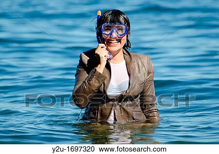 Elegant and happy wet woman in the water with a diving mask and a suit View Large Photo Image Stock Image - Elegant and happy wet woman in the water with a diving mask and a suit. Fotosearch