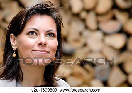 Elegant and happy woman watching up View Large Photo Image Stock Photo - Elegant and happy woman watching up. Fotosearch