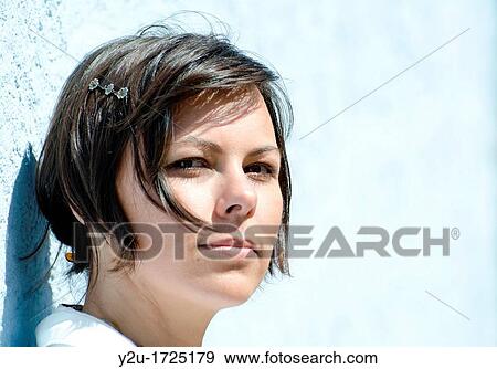 Elegant and smiling woman with white shirt and blue background View Large Photo Image Stock Photo - Elegant and smiling woman with white shirt and blue background. Fotosearch