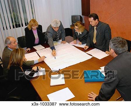 Elevated view of a business meeting around a conference table View Large Photo Image Stock Photo - Elevated view of a business meeting around a conference table. Fotosearch
