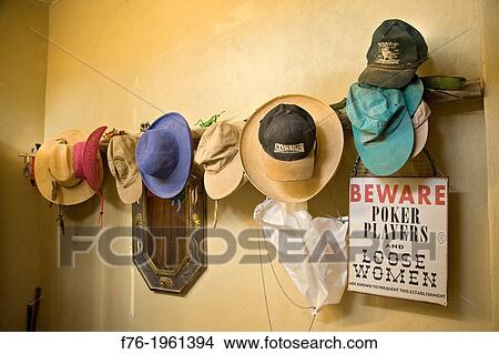 Eleven hats on wall above Beware Sign in Sante Fe home. View Large Photo Image Picture - Eleven hats on wall above Beware Sign in Sante Fe home.. Fotosearch