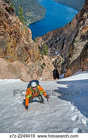 Elijah Weber climbing the Chockstone Couloir, AKA the Boy Scout Couloir an alpine route which is rated Grade 3, Class 4 and located on The Grand Mogul in the Sawtooth Mountains in central Idaho. View Large Photo Image Stock Photo - Elijah Weber climbing the Chockstone Couloir, AKA the Boy Scout Couloir an alpine route which is rated Grade 3, Class 4 and located on The Grand Mogul in the Sawtooth Mountains in central Idaho.. Fotosearch
