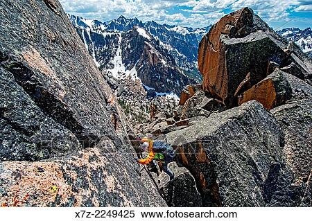 Elijah Weber climbing the Chockstone Couloir, AKA the Boy Scout Couloir an alpine route which is rated Grade 3, Class 4 and located on The Grand Mogul in the Sawtooth Mountains in central Idaho. View Large Photo Image Stock Photography - Elijah Weber climbing the Chockstone Couloir, AKA the Boy Scout Couloir an alpine route which is rated Grade 3, Class 4 and located on The Grand Mogul in the Sawtooth Mountains in central Idaho.. Fotosearch