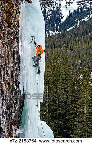 Picture - Elijah Weber ice climbing a route called Thin Chance which is rated WI-4, 5 and located in Hyalite Canyon in the Gallatin Mountains near the city of Bozeman in southern Montana.. Fotosearch