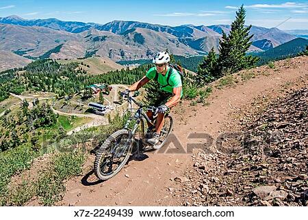 Stock Photo - Elijah Weber mountain biking the Saddle Up Flow Trail on Bald Mountain at Sun Valley Resort near the cities of Ketchum and Sun Valley in central Idaho.. Fotosearch