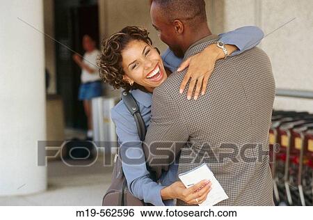 embracing at an airport View Large Photo Image Stock Photograph - embracing at an airport. Fotosearch
