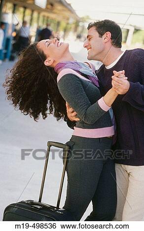 embracing/dancing couple at a train station View Large Photo Image Stock Photograph - embracing/dancing couple at a train station. Fotosearch