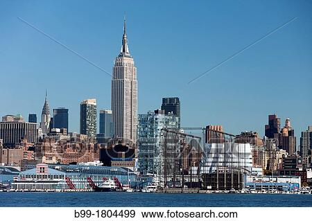 Stock Photo - EMPIRE STATE BUILDING CHELSEA PIERS HUDSON RIVER MIDTOWN MANHATTAN NEW YORK CITY USA. Fotosearch
