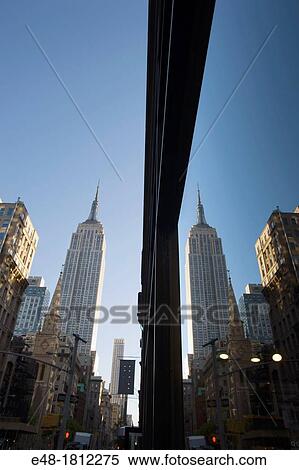EMPIRE STATE BUILDING REFLECTED IN WINDOW ON FIFTH AVENUE MANHATTAN NEW YORK CITY USA View Large Photo Image Stock Photography - EMPIRE STATE BUILDING REFLECTED IN WINDOW ON FIFTH AVENUE MANHATTAN NEW YORK CITY USA. Fotosearch