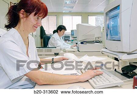 Stock Image - Employees working at administration offices of hospital. Fotosearch