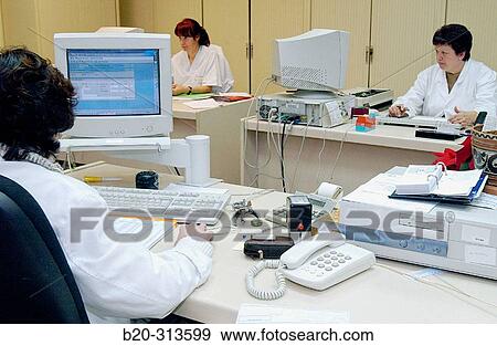 Employees working at administration offices of hospital View Large Photo Image Stock Photo - Employees working at administration offices of hospital. Fotosearch
