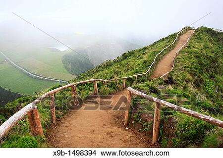 Empty walking trail in foggy weather nearby Sete Cidades crater Sao Miguel island, Azores, Portugal View Large Photo Image Picture - Empty walking trail in foggy weather nearby Sete Cidades crater Sao Miguel island, Azores, Portugal. Fotosearch