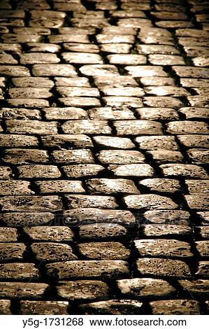 empty wet pavement cobbles street road in rain at night View Large Photo Image Stock Photo - empty wet pavement cobbles street road in rain at night. Fotosearch