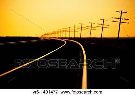 Endless line of telephone poles along rail road tracks at sunrise Imperial Valley, CA View Large Photo Image Stock Photo - Endless line of telephone poles along rail road tracks at sunrise Imperial Valley, CA. Fotosearch