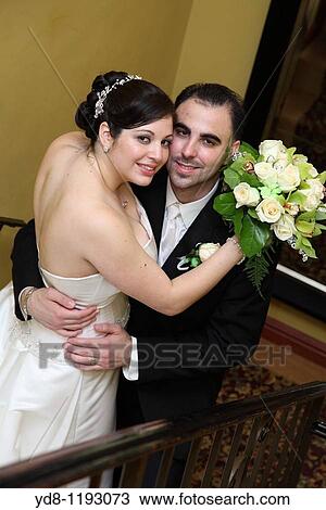 Stock Image - Engaged couple looking at the camera. Fotosearch