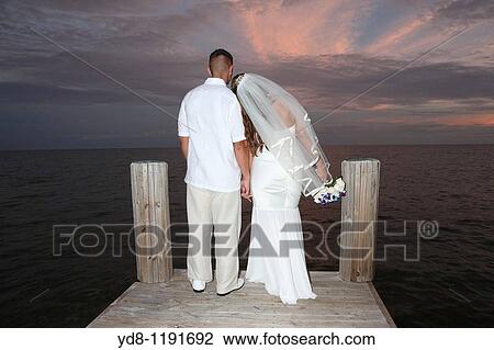 Engaged couple on a bridge overlooking the sea View Large Photo Image Stock Image - Engaged couple on a bridge overlooking the sea. Fotosearch