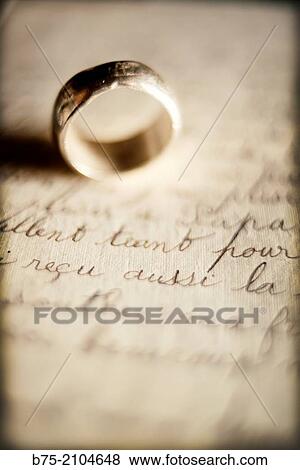 Engagement ring on top of a text of a handwritten letter View Large Photo Image Stock Photo - Engagement ring on top of a text of a handwritten letter. Fotosearch