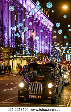 England, London, Soho, Oxford Street, Chirstmas decorations and London taxi. View Large Photo Image Picture - England, London, Soho, Oxford Street, Chirstmas decorations and London taxi.. Fotosearch