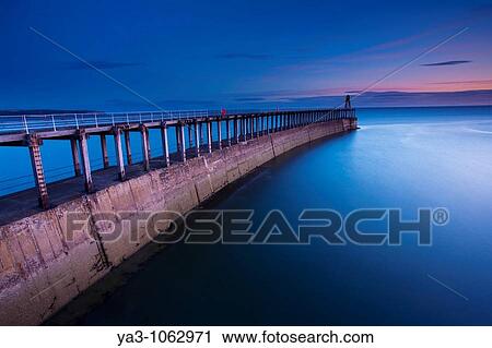 England, North Yorkshire, Whitby One of the entrance piers of Whitby Harbour at dawn View Large Photo Image Stock Image - England, North Yorkshire, Whitby One of the entrance piers of Whitby Harbour at dawn. Fotosearch