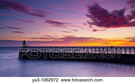 England, North Yorkshire, Whitby One of the entrance piers of Whitby Harbour at dawn View Large Photo Image Stock Image - England, North Yorkshire, Whitby One of the entrance piers of Whitby Harbour at dawn. Fotosearch