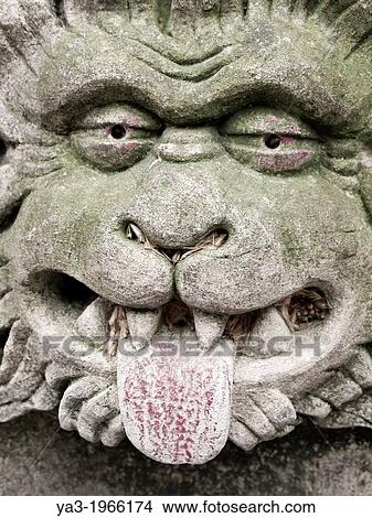 Picture - England, North Yorkshire, York City. Gargoyle on bench in Dean's Park in the grounds of York Minster cathedral.. Fotosearch