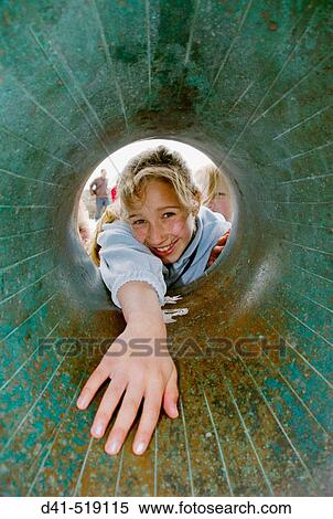 Stock Photography - England, Sussex, Brighton, child laughing through donut sculpture. Fotosearch