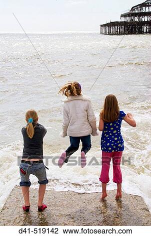 England, Sussex, Brighton, children playing on groyne View Large Photo Image Stock Image - England, Sussex, Brighton, children playing on groyne. Fotosearch