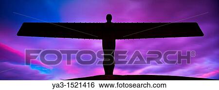 England, Tyne and Wear, Gateshead The iconic Angel of the North statue by Antony Gormley, silhouetted against an atmospheric sky View Large Photo Image Stock Photograph - England, Tyne and Wear, Gateshead The iconic Angel of the North statue by Antony Gormley, silhouetted against an atmospheric sky. Fotosearch