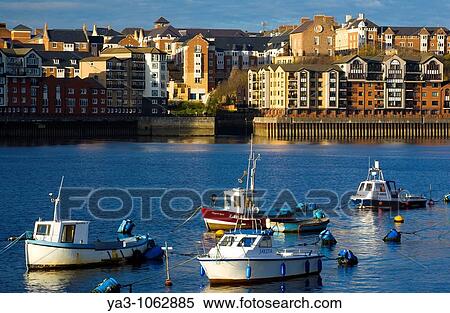 England, Tyne & Wear, North Shields Boats moored on the River Tyne with a complex of new apartments located on the North Shields Quayside in the distance View Large Photo Image Stock Photography - England, Tyne & Wear, North Shields Boats moored on the River Tyne with a complex of new apartments located on the North Shields Quayside in the distance. Fotosearch