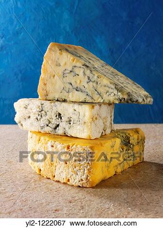 Stock Photo - English blue cheese wedges - stilton, white stilton amd blacksticks. Fotosearch