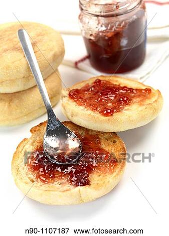 Stock Photo - English muffins isolated against a blue background. Fotosearch
