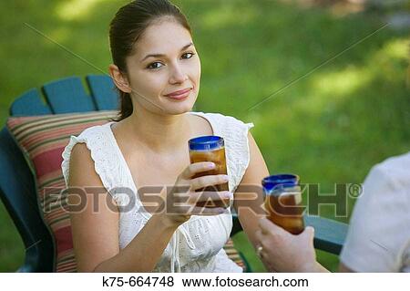 Enjoying a glass of iced tea View Large Photo Image Stock Photo - Enjoying a glass of iced tea. Fotosearch